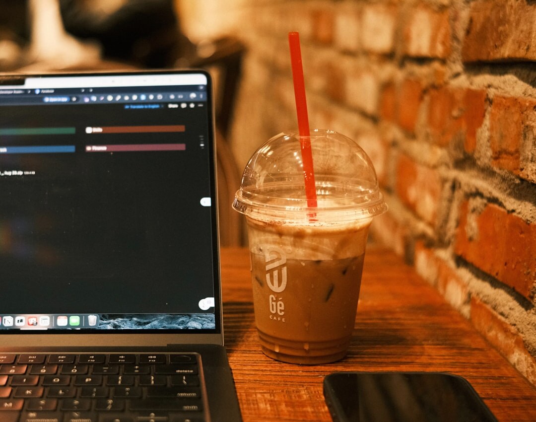 Journalist writing content on laptop in cafe