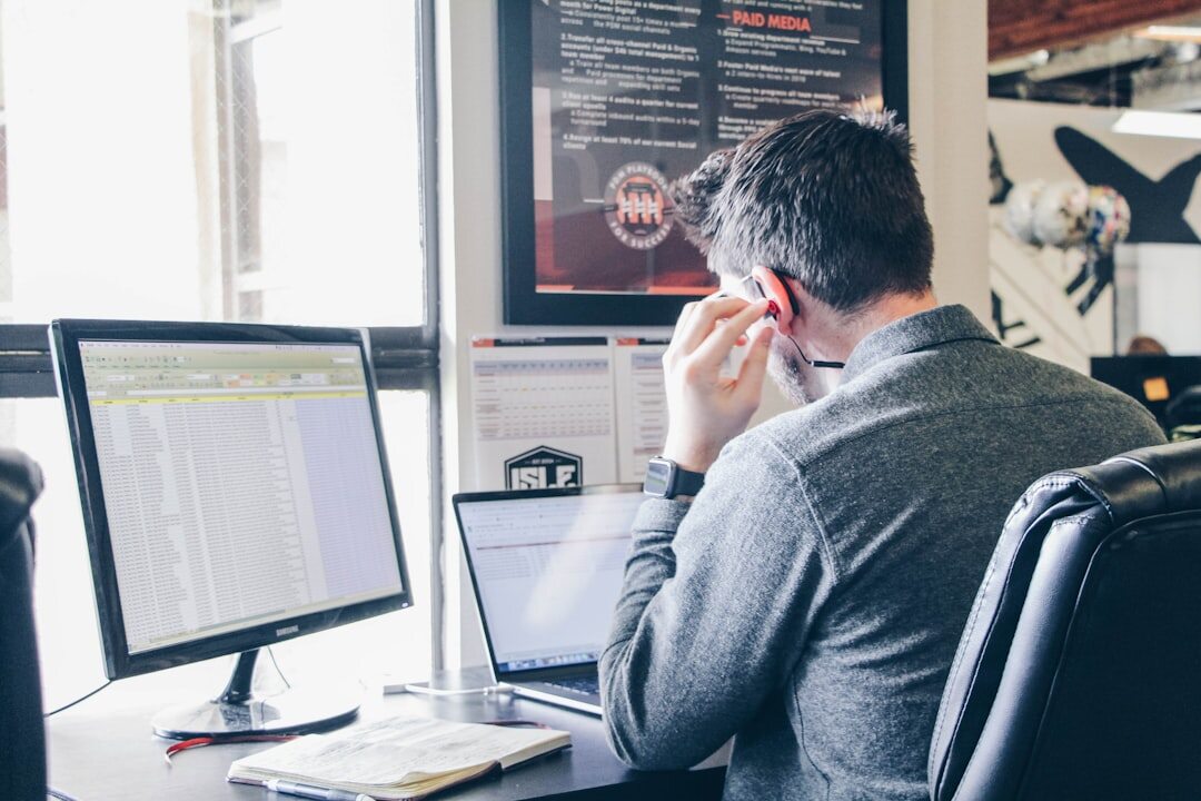 Journalist fact-checking information on multiple screens